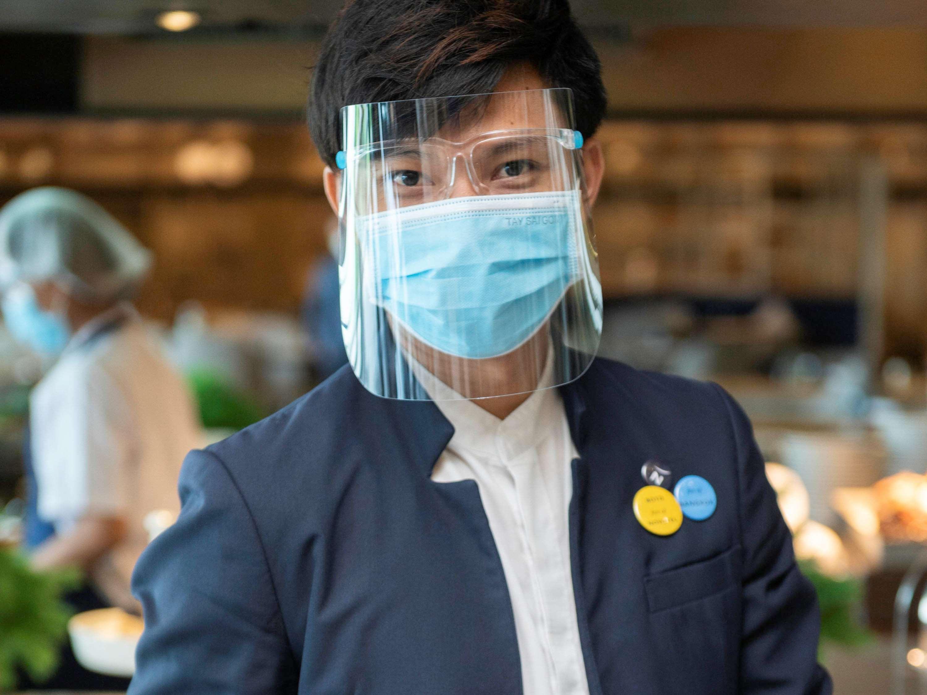 Novotel Chennai Sipcot 외부 사진 A Thai Airways employee wearing a face shield