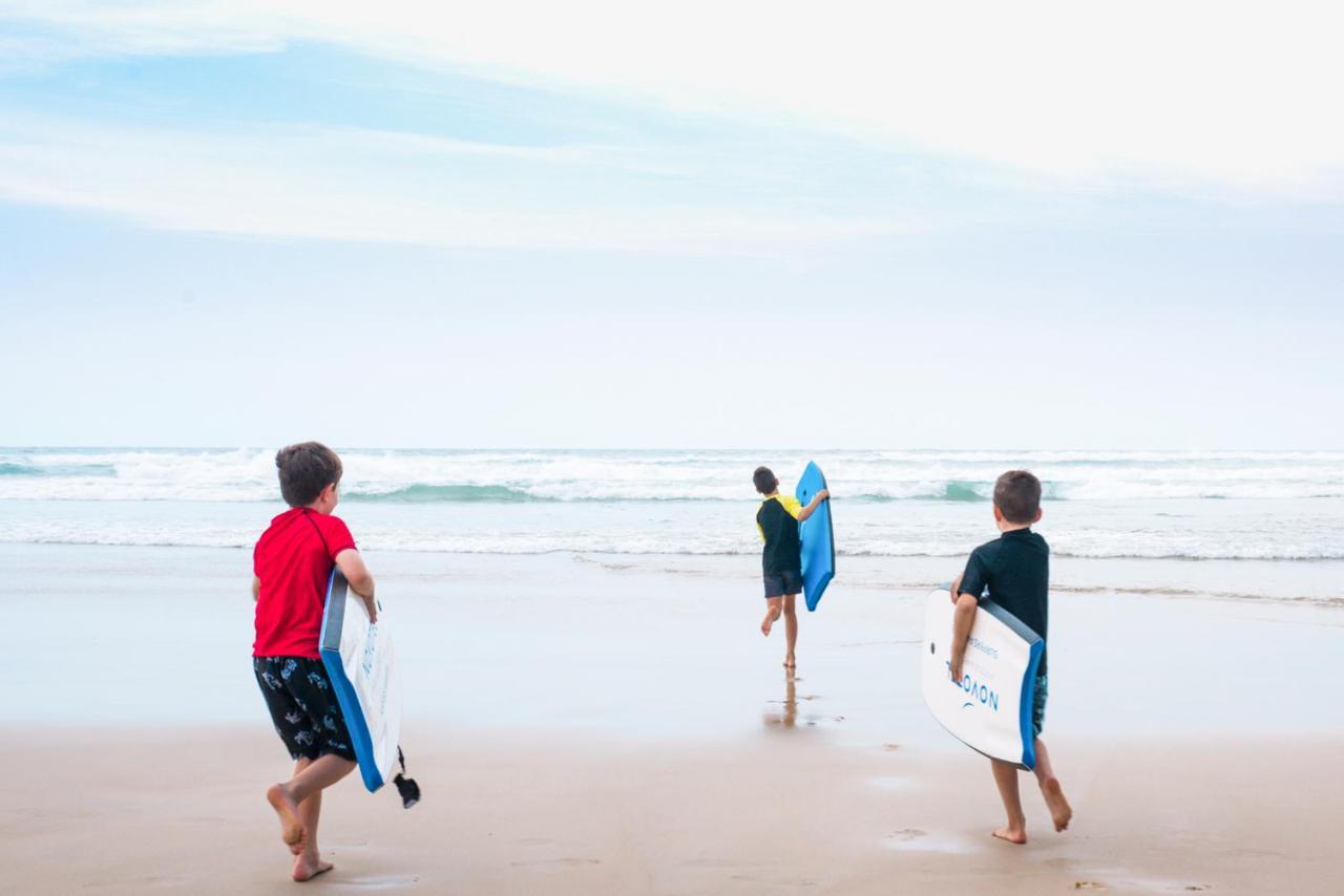 Novotel Chennai Sipcot 외부 사진 Children learning to surf at the beach